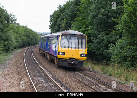 A diesel passenger train on the mainline approaching Deighton station near Huddersfield, West Yorkshire, England Stock Photo