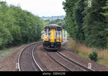 A diesel passenger train on the mainline approaching Deighton station near Huddersfield, West Yorkshire, England Stock Photo