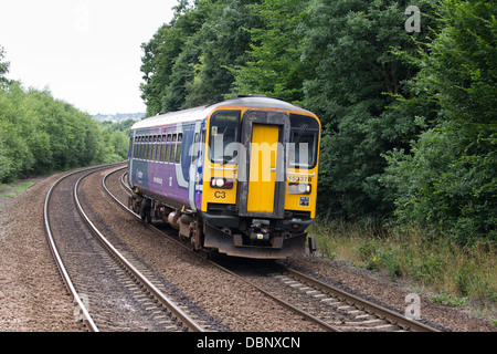 A diesel passenger train on the mainline approaching Deighton station near Huddersfield, West Yorkshire, England Stock Photo