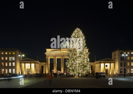 Illuminated Christmas tree and Brandenburg Gate on square Pariser Platz in the evening, Berlin Stock Photo