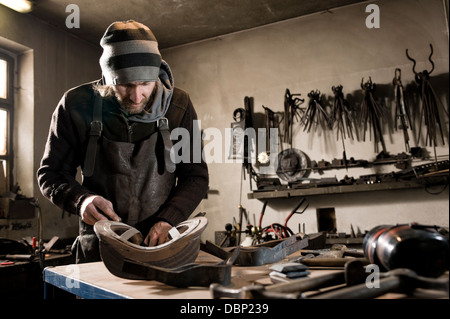 Blacksmith working in shop, Landshut, Bavaria, Germany Stock Photo