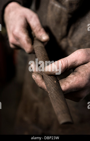 Blacksmith holding Iron Pipe, Landshut, Bavaria, Germany Stock Photo