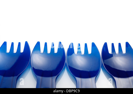 four disposable plastic forks on a white background Stock Photo