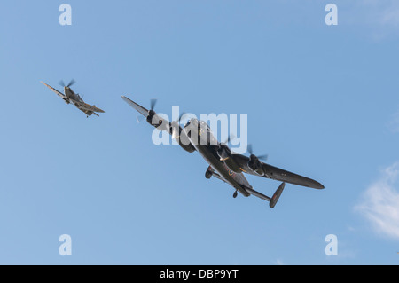 Lancaster bomber and Spitfire flypast in close formation at the Goodwood Revival 2012 Stock Photo