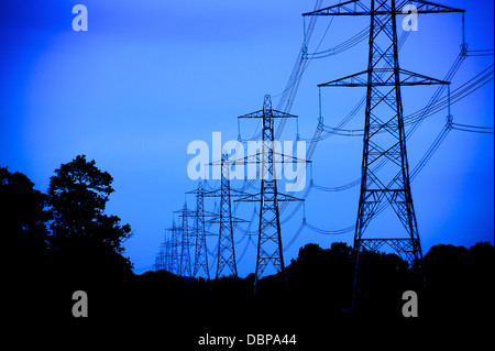 Transporting power for the national grid, pylons support the high voltage cables. Stock Photo