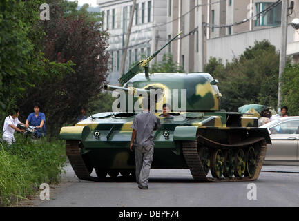 HOMEMADE TANK TAKES TO THE STREETS Residents of Hangzhou, China, may have had cause for alarm when they stepped outside to see a T60 tank rolling through the streets but the 10 ton vehicle was in fact a homemade full-scale replica of the killing machine. The tank took a team of a dozen workers seven months to make and at 6.24m x 3.27m can reach a top speed of 15 mph. The owner plan Stock Photo