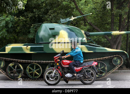 HOMEMADE TANK TAKES TO THE STREETS Residents of Hangzhou, China, may have had cause for alarm when they stepped outside to see a T60 tank rolling through the streets but the 10 ton vehicle was in fact a homemade full-scale replica of the killing machine. The tank took a team of a dozen workers seven months to make and at 6.24m x 3.27m can reach a top speed of 15 mph. The owner plan Stock Photo