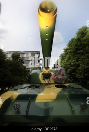 HOMEMADE TANK TAKES TO THE STREETS Residents of Hangzhou, China, may have had cause for alarm when they stepped outside to see a T60 tank rolling through the streets but the 10 ton vehicle was in fact a homemade full-scale replica of the killing machine. The tank took a team of a dozen workers seven months to make and at 6.24m x 3.27m can reach a top speed of 15 mph. The owner plan Stock Photo