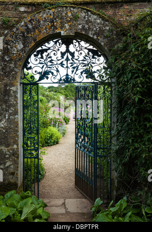 The ornately gated entrance to the colourful walled garden of Rousham House in late June, Oxfordshire, England Stock Photo