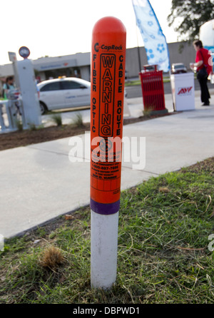 Warning cone alerting workers of buried fiber optic cables on street in Austin, Texas. Stock Photo