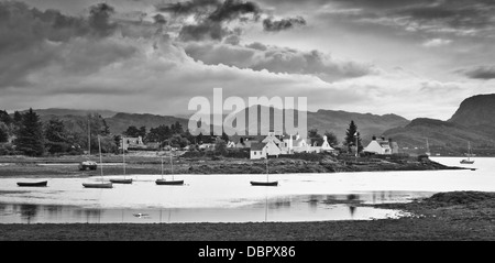 A selection of small boats take shelter as storm clouds build over the village of Plockton, Loch Carron on Scotland's West coast Stock Photo