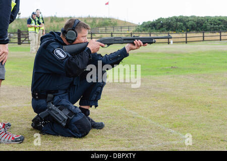 Ballykinlar, Northern Ireland. 2nd August 2013 - A Finnish police officer fires a pump-action shotgun at a firing range Stock Photo