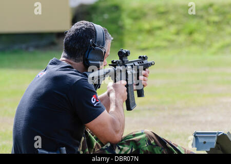 Ballykinlar, Northern Ireland. 2nd August 2013 - A man fires a Colt M4A1 Credit:  Stephen Barnes/Alamy Live News Stock Photo