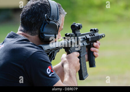 Ballykinlar, Northern Ireland. 2nd August 2013 - A man fires a Colt M4A1  Credit:  Stephen Barnes/Alamy Live News Stock Photo