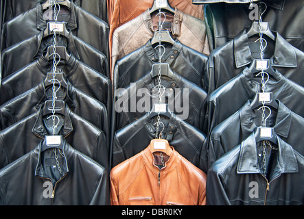 Many leather jackets hanging in shop Stock Photo