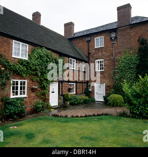 Timbered red brick house attached to old three story house in Derbyshire Stock Photo