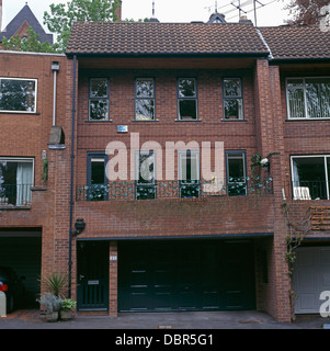 Nineties brick-built terraced house with ground-level integral garage Stock Photo