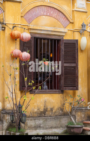 Facade of colonial-style building with silk lanterns and wooden shutters in Old Quarter, Hoi An, Vietnam, Southeast Asia Stock Photo