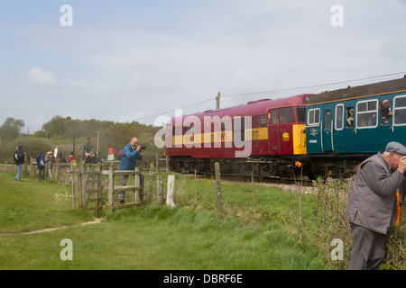 Diesel Locomotive heads a special train past railway enthusiasts during the 2013 Diesel Gala on the Swanage Steam Railway Dorset Stock Photo