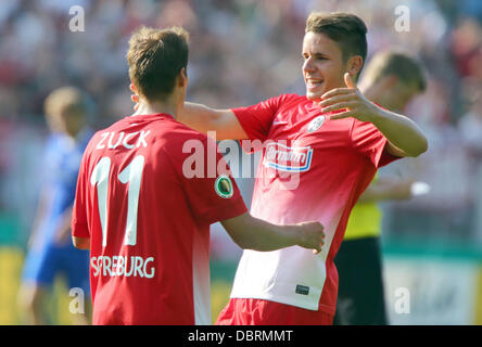 London, UK. 03rd Aug, 2013. Neustrelitz, Germany. 3rd August, 2013. Freiburg's Hendrick Zuck and Christian Guenter (R) celebrate after Zuck's 0-1 goal during the first round DFB Cup match between TSG Neustrelitz and SC Freiburg at Parkstadion in Neustrelitz, Germany, 03 August 2013. (PLEASE NOTE: The DFB prohibits the utilisation and publication of sequential pictures on the internet and other online media during the match (including half-time). BLOCKING PERIOD! The DFB permits the further utilisation and publication of the pictures for mobile services (especially MMS) and for DVB-H and DMB on Stock Photo