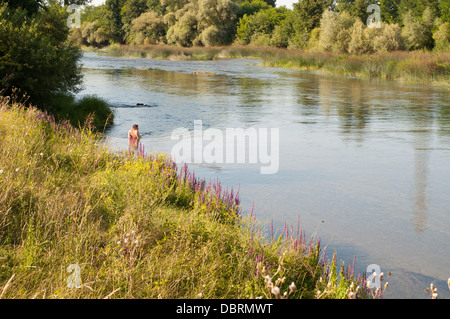 Man sitting in river Stock Photo