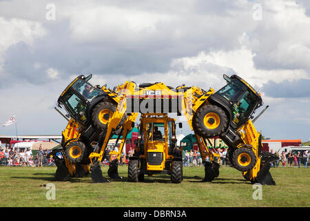 Brackenfield, Derbyshire, U.K. 3rd August 2013. The J.C. Balls Digger Dance Team perform at the 2013 Cromford Steam Rally. The annual steam event is in its 43rd year since the society was formed in 1970. The Digger Dance team have been performing since 2004. Their routine is choreographed to music and includes a number of exceptionally daring manoeuvres. Credit:  Mark Richardson/Alamy Live News Stock Photo