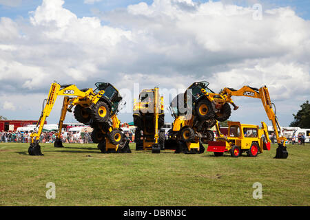 Brackenfield, Derbyshire, U.K. 3rd August 2013. The J.C. Balls Digger Dance Team perform at the 2013 Cromford Steam Rally. The annual steam event is in its 43rd year since the society was formed in 1970. The Digger Dance team have been performing since 2004. Their routine is choreographed to music and includes a number of exceptionally daring manoeuvres. Credit:  Mark Richardson/Alamy Live News Stock Photo