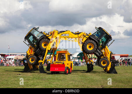 Brackenfield, Derbyshire, U.K. 3rd August 2013. The J.C. Balls Digger Dance Team perform at the 2013 Cromford Steam Rally. The annual steam event is in its 43rd year since the society was formed in 1970. The Digger Dance team have been performing since 2004. Their routine is choreographed to music and includes a number of exceptionally daring manoeuvres. Credit:  Mark Richardson/Alamy Live News Stock Photo