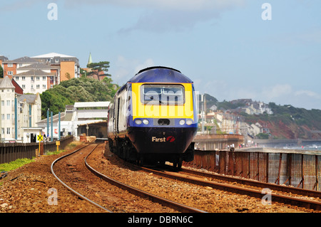 First Great Western high speed train passing along the sea wall at Marine Parade in Dawlish heading west Stock Photo