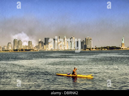 Sept. 12, 2001 - New York, New York, US - A man paddling a kayak on the Hudson River near Jersey City, N.J. seems to ignore the smoke still billowing into the sky over lower Manhattan from ground zero, the former site of the World Trade Center, the day after terrorists crashed two hijacked airliners bringing down the twin 110-story towers. (Credit Image: © Arnold Drapkin/ZUMAPRESS.com) Stock Photo