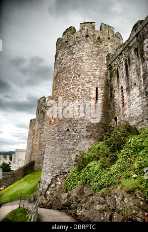 CONWY, Wales — The imposing turrets and walls of Conwy Castle, a 13th-century medieval fortress, loom against a threatening cloudy sky in North Wales, United Kingdom. This UNESCO World Heritage Site, built by King Edward I, showcases the intimidating presence of medieval military architecture, its stone fortifications stark against the dramatic backdrop. Stock Photo