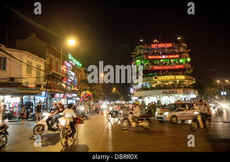 HANOI, Vietnam - An intersection with busy traffic at night in Hanoi's Old Quarter, next to Hoan Kiem Lake. Stock Photo