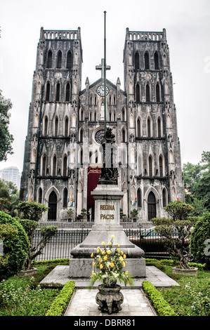 HANOI, Vietnam - St. Joseph's Cathedral is a church on Nha Tho (Church) Street in the Hoan Kiem District of Hanoi, Vietnam. The late 19th-century Gothic Revival (Neo-Gothic style) church serves as the cathedral of the Roman Catholic Archdiocese of Hanoi to nearly 4 million Catholics in the country. Stock Photo
