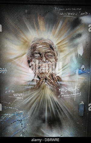 London 3 August 2013.  Portrait of 'Madiba' see on a doorway on Brick Lane in East London by street artist Paul Donsmith.  Credit David Mbiyu/Alamy Live News Stock Photo