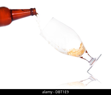 beer pouring from bottle in to the glass isolated on a white background Stock Photo