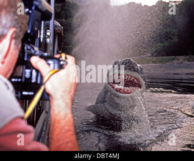 On a back-lot tour at Universal Studios in Hollywood, California, a tourist snaps a photo of Jaws, an animated great white shark and 1970s movie star. Stock Photo