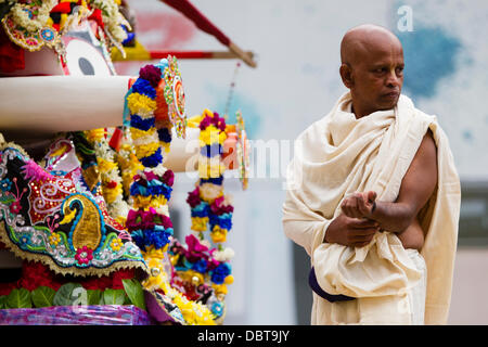 Leicester, UK, 4th August 2013.  A Hare Krishna follower atop a chariot during the Rathayatra street festival in Leicester's City Centre.   Three 40ft chariots were hand pulled through the City, accompanied by dance and music.  Rathayatra is a 5,000 year old festival originating in Jagannatha Puri in India. Credit:  Graham Wilson/Alamy Live News Stock Photo