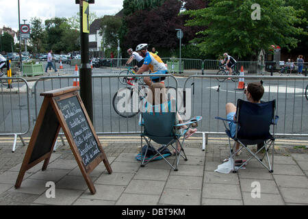 Wimbledon London, UK. 4th Aug,2013. Cyclists take part in the London-surrey 100 ride passing through Wimbledon village. Up to 20,000 cyclists are expected to ride the 100 mile route through south west London and Surrey Credit:  amer ghazzal/Alamy Live News Stock Photo