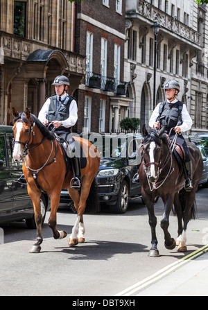 Two mounted British Metropolitan police officers on patrol, Great George Street, London, England, UK. Stock Photo