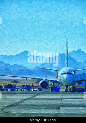 An aeroplane being loaded with luggage at hurghada airport with the red sea mountains in the background
