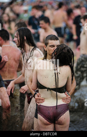 A couple kissing in a mud pool of the Przystanek Woodstock music festival, Kostrzyn, Poland. Stock Photo