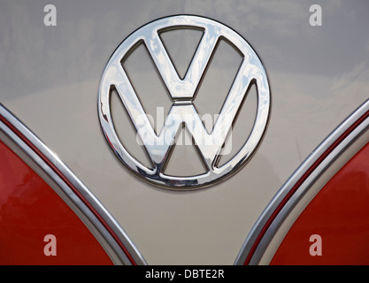 Horizontal close up of white VW T2 camper van logo on orange bonnet ...