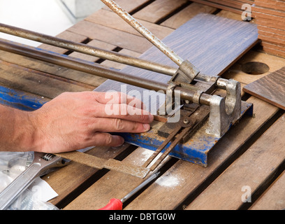Ceramic cutting machine being used by a man Stock Photo