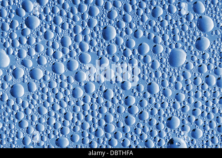 Abstract blue macro background with water drops on glass Stock Photo
