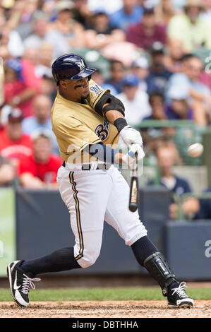 Milwaukee, Wisconsin, USA. 4th Aug, 2013. August 4, 2013: Milwaukee Brewers center fielder Carlos Gomez #27 hits a sacrifice fly to right in the 6th inning during the Major League Baseball game between the Milwaukee Brewers and the Washington Nationals at Miller Park in Milwaukee, WI. Brewers lead the Nationals 6-5 in the 7th inning. John Fisher/CSM. Credit:  csm/Alamy Live News Stock Photo