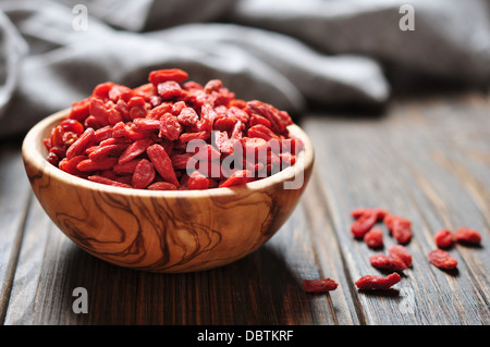 wooden bowl with goji berries on the table closeup Stock Photo