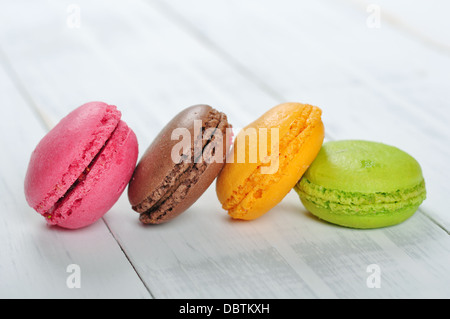 Colorful macaroons isolated over white wooden background Stock Photo