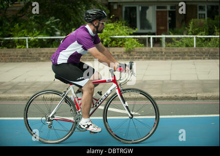 The Mall, London, UK. 04th Aug, 2013. The Mall, London, UK 4th Aug, 2013.  Rider completing the London Surrey 100 through the traffic-free roads of London, photographed from the media bus © Malcolm Park/Alamy Live News Credit:  Malcolm Park/Alamy Live News Stock Photo