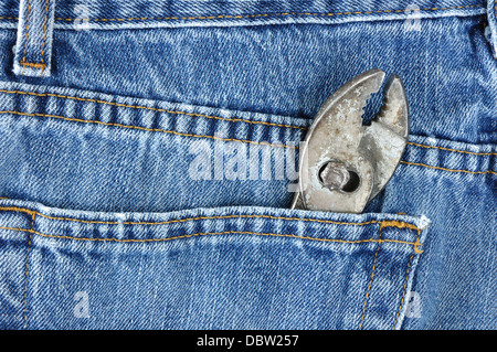 Pliers in the back pocket of a pair of denim jeans Stock Photo