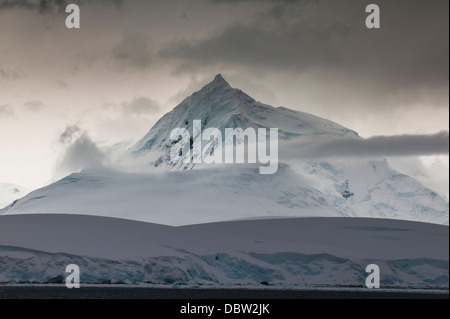 Dark clouds over the mountains and glaciers of Port Lockroy research station, Antarctica, Polar Regions Stock Photo